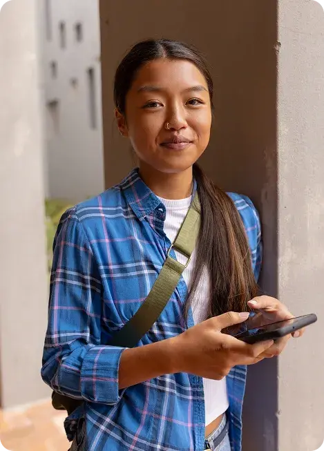 Girl holding smartphone and smiling